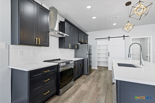 9923 Loma Alta Cir, Converse, TX 78109 - kitchen featuring appliances with stainless steel finishes, wall chimney exhaust hood, a barn door, backsplash, and light countertops