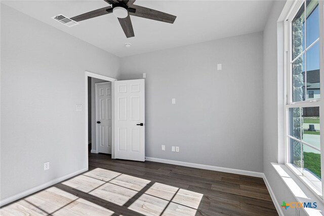 9923 Loma Alta Cir, Converse, TX 78109 - unfurnished room featuring a ceiling fan, healthy amount of natural light, and dark wood-style flooring