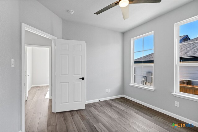 9923 Loma Alta Cir, Converse, TX 78109 - spare room with a ceiling fan, wood finished floors, and a smoke detector