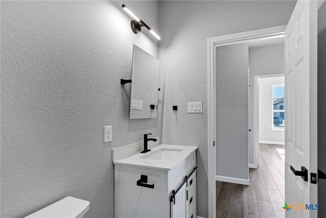 9923 Loma Alta Cir, Converse, TX 78109 - bathroom featuring vanity, a textured wall, and wood finished floors