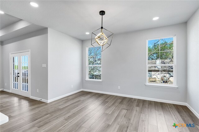 9923 Loma Alta Cir, Converse, TX 78109 - empty room featuring wood finished floors, recessed lighting, and french doors