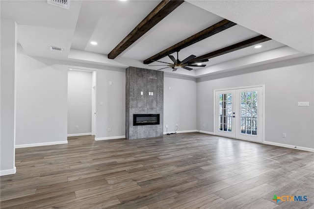 9923 Loma Alta Cir, Converse, TX 78109 - unfurnished living room featuring a ceiling fan, wood finished floors, beam ceiling, a fireplace, and recessed lighting
