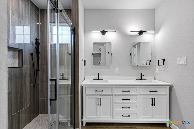 9923 Loma Alta Cir, Converse, TX 78109 - full bath featuring a stall shower, double vanity, and a textured wall