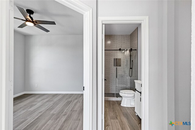 9923 Loma Alta Cir, Converse, TX 78109 - bathroom with a stall shower, ceiling fan, wood finished floors, and vanity