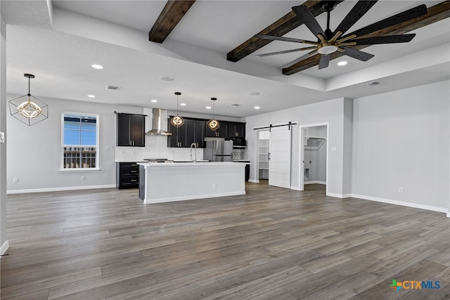 9923 Loma Alta Cir, Converse, TX 78109 - unfurnished living room with a barn door, recessed lighting, ceiling fan, a chandelier, and wood finished floors