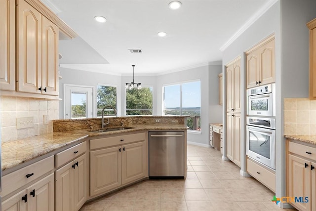10306 Vance Circle Rd, Jonestown, TX 78645 - kitchen featuring appliances with stainless steel finishes, a peninsula, ornamental molding, backsplash, and light stone countertops