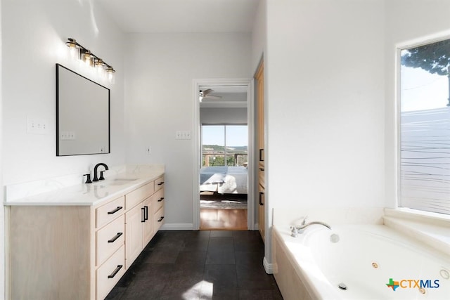 10306 Vance Circle Rd, Jonestown, TX 78645 - bathroom with vanity, a tub with jets, ensuite bath, tile patterned flooring, and a ceiling fan