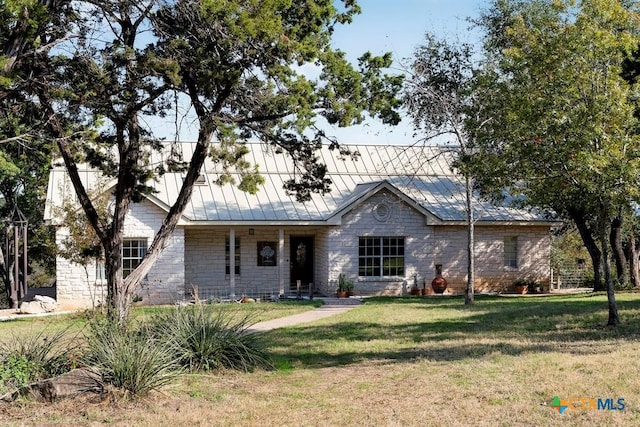 10306 Vance Circle Rd, Jonestown, TX 78645 - ranch-style house with a front lawn, a metal roof, and a standing seam roof