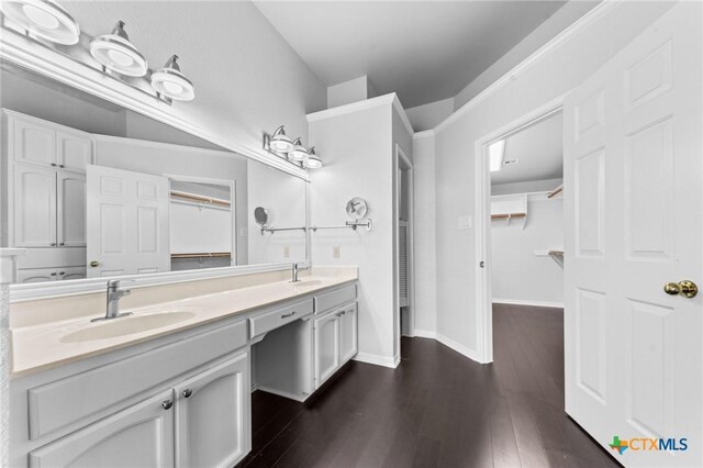 1546 W Fm 93rd Hwy Unit 207, Temple, TX 76502 - bathroom with double vanity, a spacious closet, wood finished floors, and baseboards