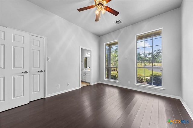 1546 W Fm 93rd Hwy Unit 207, Temple, TX 76502 - unfurnished bedroom featuring baseboards, wood finished floors, ensuite bath, and ceiling fan