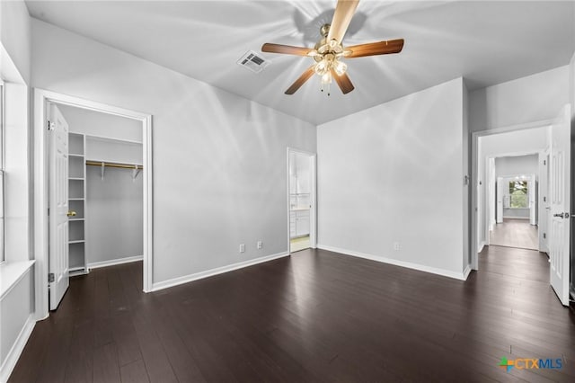 1546 W Fm 93rd Hwy Unit 207, Temple, TX 76502 - unfurnished bedroom featuring dark wood-type flooring, a spacious closet, a closet, and baseboards