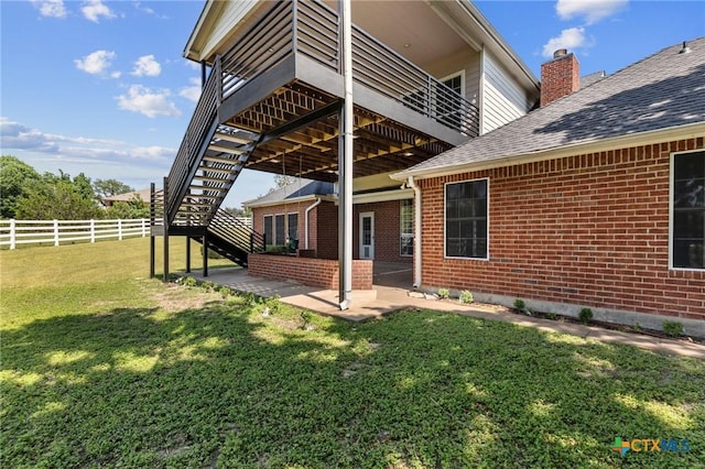 1546 W Fm 93rd Hwy Unit 207, Temple, TX 76502 - back of property with brick siding, a patio, stairs, and roof with shingles