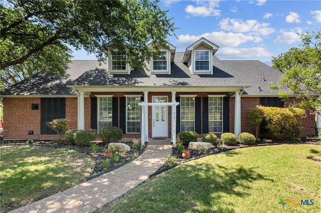 1546 W Fm 93rd Hwy Unit 207, Temple, TX 76502 - cape cod house featuring brick siding, a front lawn, and a shingled roof