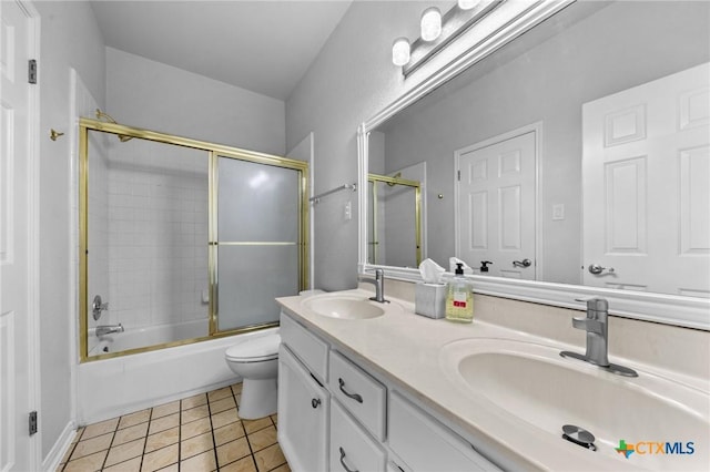 1546 W Fm 93rd Hwy Unit 207, Temple, TX 76502 - full bathroom featuring toilet, double vanity, bath / shower combo with glass door, and tile patterned floors