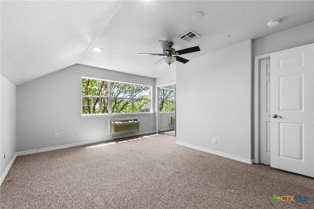 1546 W Fm 93rd Hwy Unit 207, Temple, TX 76502 - unfurnished bedroom with an AC wall unit, carpet floors, baseboards, lofted ceiling, and a ceiling fan