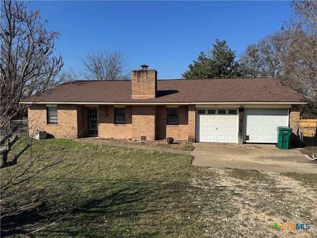 view of front of house featuring a front lawn, fence, a garage, brick siding, and a chimney