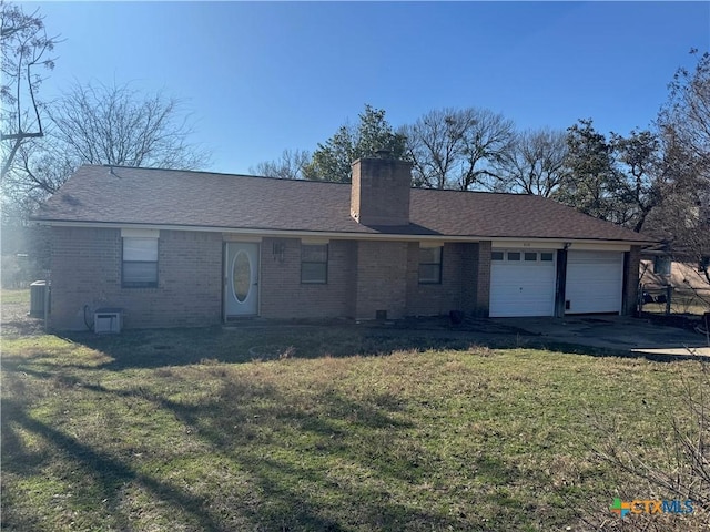 single story home featuring a garage and a front yard