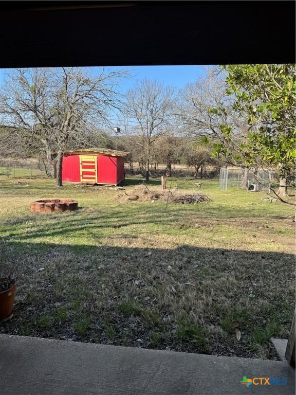 view of yard featuring an outbuilding and a shed