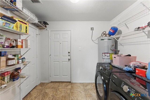 7611 Presidio Crk, Boerne, TX 78015 - washroom featuring a textured ceiling, electric water heater, baseboards, laundry area, and washing machine and clothes dryer