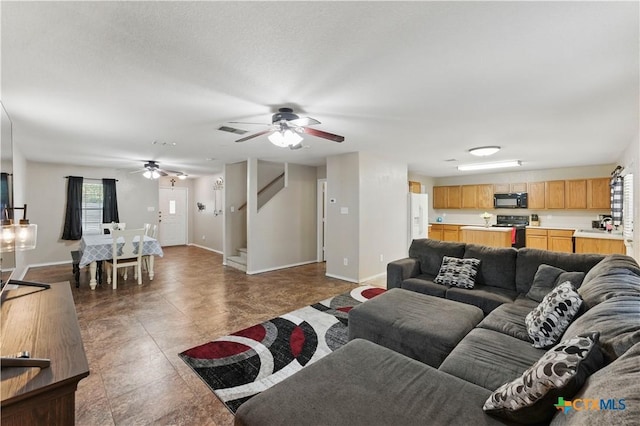 7611 Presidio Crk, Boerne, TX 78015 - living room featuring stairway, baseboards, visible vents, and ceiling fan