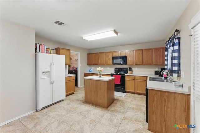 7611 Presidio Crk, Boerne, TX 78015 - kitchen with visible vents, a sink, black appliances, light countertops, and a center island