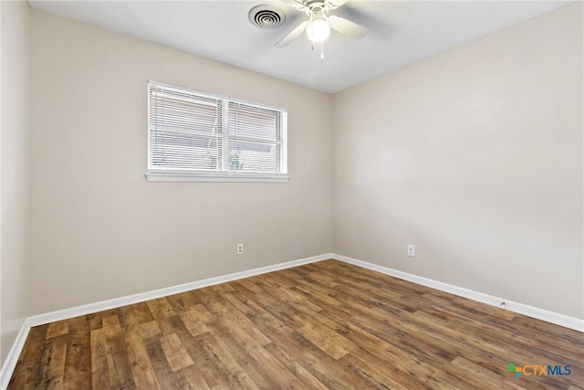 empty room featuring baseboards, visible vents, ceiling fan, and wood finished floors