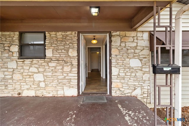 doorway to property with stone siding