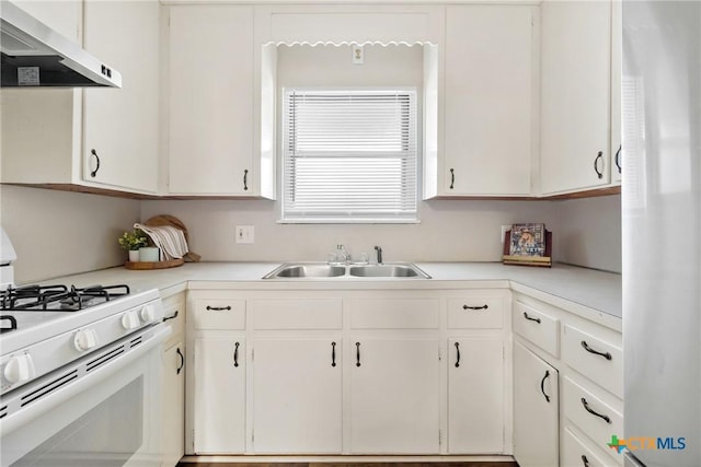 kitchen featuring white appliances, white cabinets, a sink, and exhaust hood