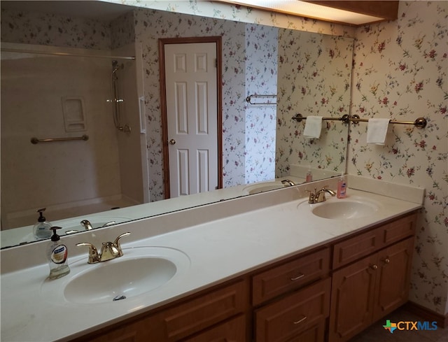 bathroom with walk in shower and vanity