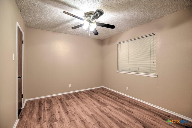 2006 Canyon Creek Dr, Temple, TX 76502 - spare room featuring wood finished floors, a textured ceiling, and a ceiling fan