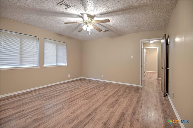 2006 Canyon Creek Dr, Temple, TX 76502 - empty room with light wood-style floors, a textured ceiling, and ceiling fan