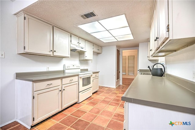 2006 Canyon Creek Dr, Temple, TX 76502 - kitchen featuring white range with electric cooktop, under cabinet range hood, a textured ceiling, and white cabinets