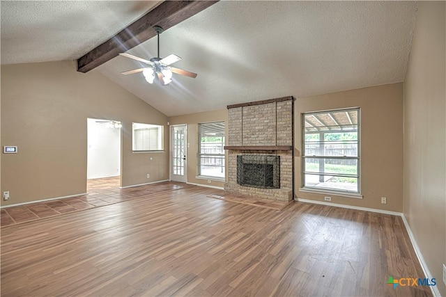 2006 Canyon Creek Dr, Temple, TX 76502 - unfurnished living room featuring light wood-type flooring, ceiling fan, healthy amount of natural light, a textured ceiling, and a fireplace