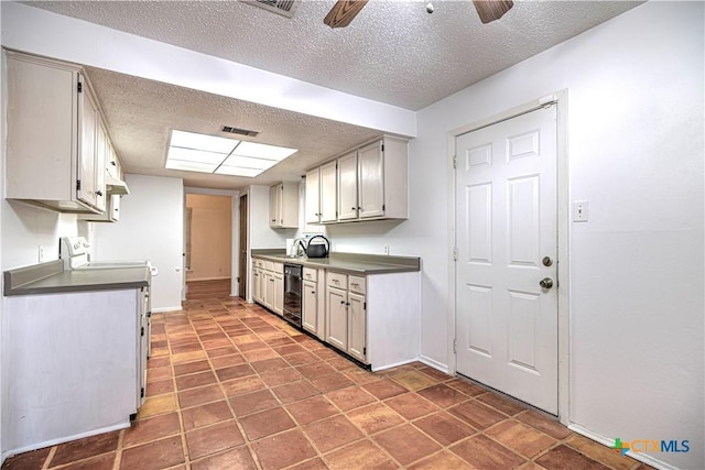 2006 Canyon Creek Dr, Temple, TX 76502 - kitchen featuring a textured ceiling, ceiling fan, stove, under cabinet range hood, and dark countertops