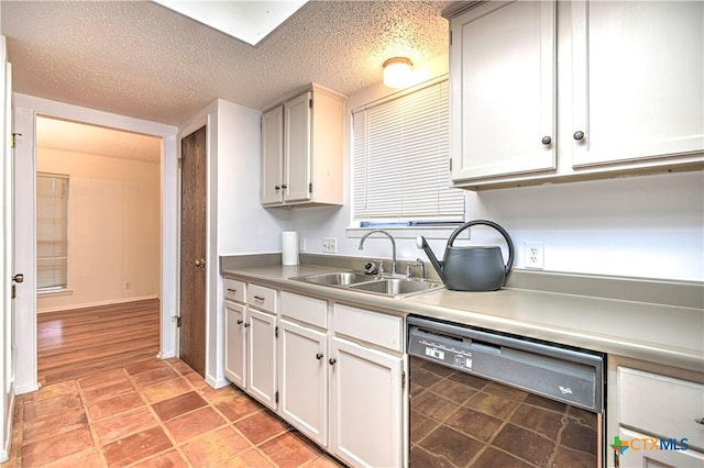 2006 Canyon Creek Dr, Temple, TX 76502 - kitchen featuring dishwashing machine, a textured ceiling, light countertops, and white cabinetry