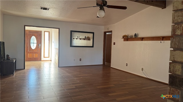 interior space with dark hardwood / wood-style floors, ceiling fan, a textured ceiling, and vaulted ceiling