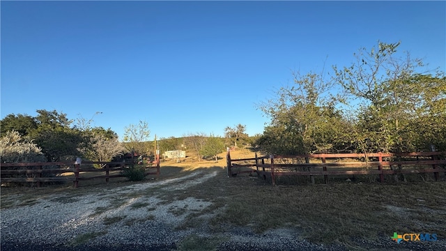 view of yard with a rural view