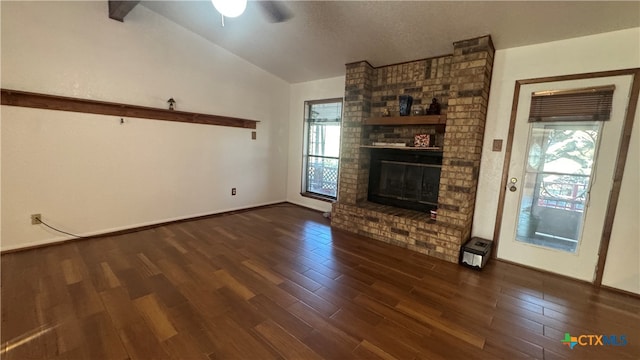 unfurnished living room with ceiling fan, dark hardwood / wood-style flooring, lofted ceiling, and a brick fireplace