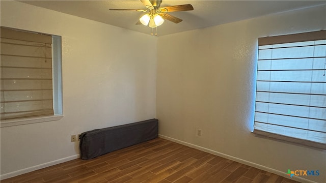 empty room with ceiling fan and wood-type flooring