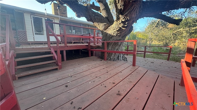 wooden deck with a sunroom