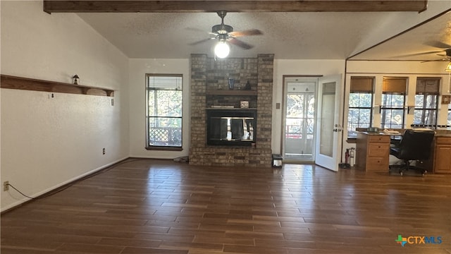 unfurnished living room featuring lofted ceiling with beams, ceiling fan, a fireplace, and dark wood-type flooring