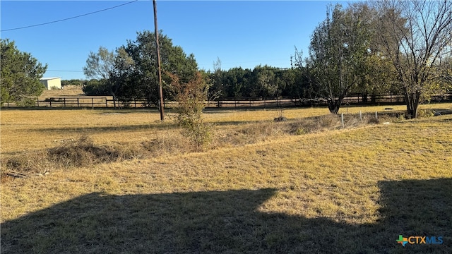 view of yard with a rural view