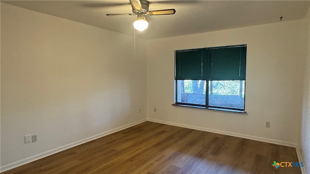 empty room featuring ceiling fan and dark wood-type flooring