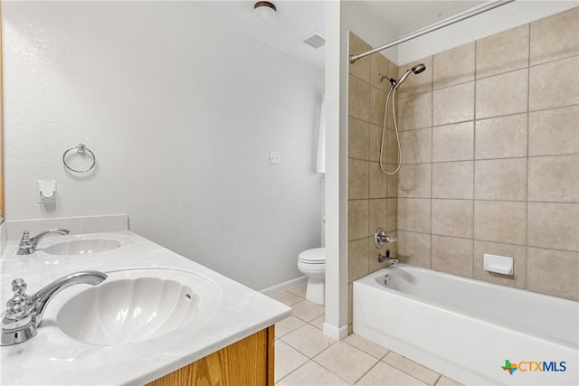 full bathroom featuring tile patterned floors, vanity, toilet, and tiled shower / bath