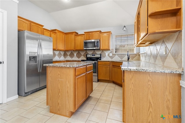 kitchen with tasteful backsplash, light stone counters, stainless steel appliances, vaulted ceiling, and a kitchen island