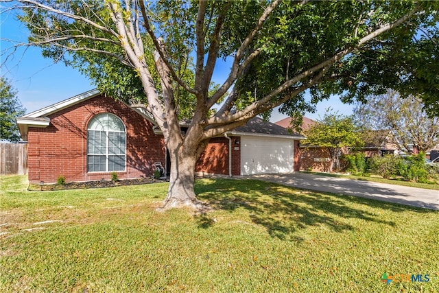 ranch-style house featuring a garage and a front yard