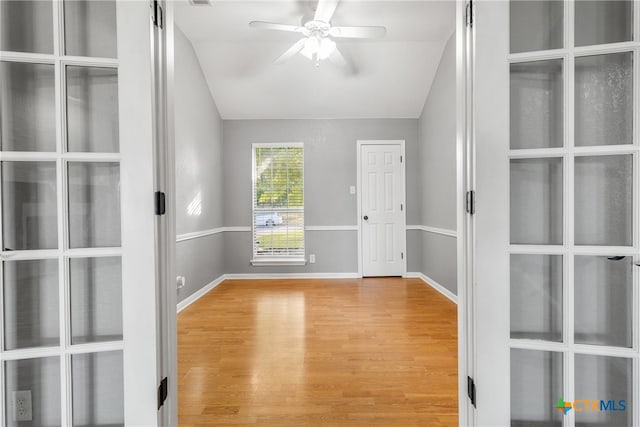 empty room featuring ceiling fan, light hardwood / wood-style floors, and lofted ceiling