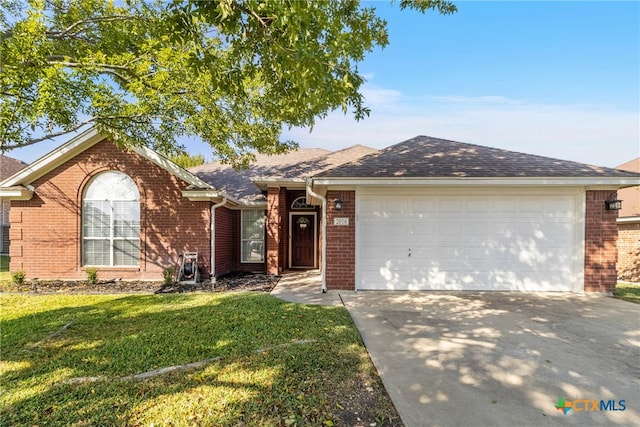 ranch-style home featuring a front lawn and a garage