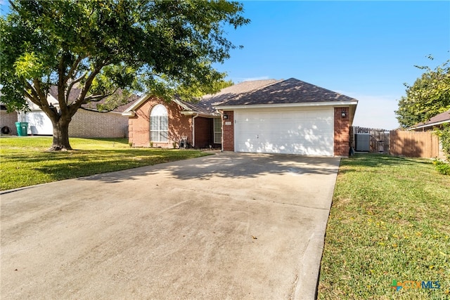 ranch-style home featuring a front lawn and a garage