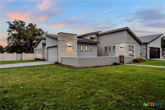 view of front facade with a lawn and a garage